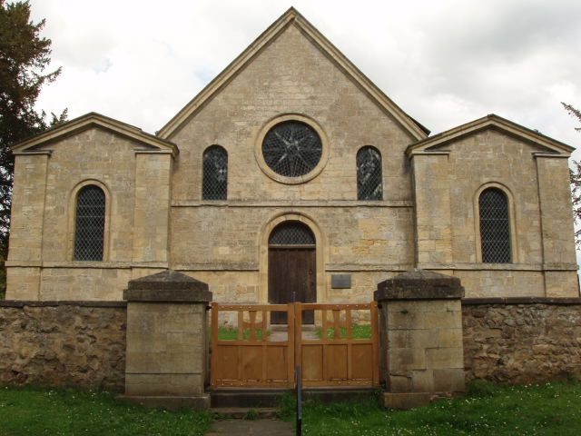 Photo of west elevation of church showing main door and double gates.